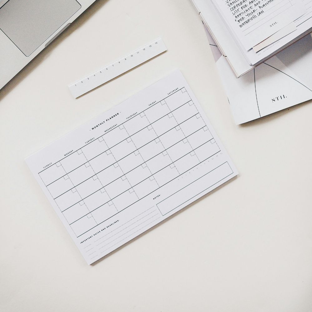 A monthly planner sitting on a desk